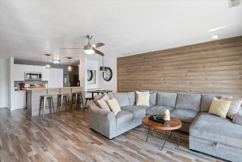 Living room with sectional sofa and wood accent wall