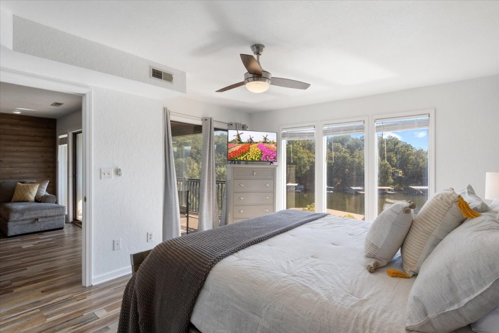 Bedroom with balcony doors and lake view