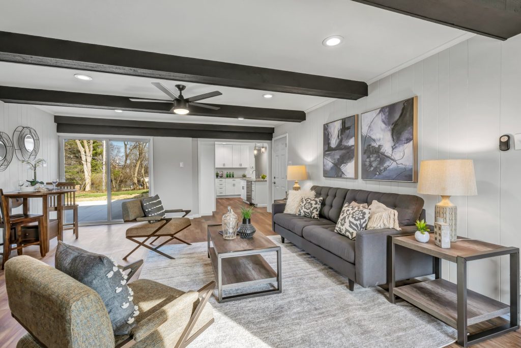 Living room with exposed beams and ceiling fan