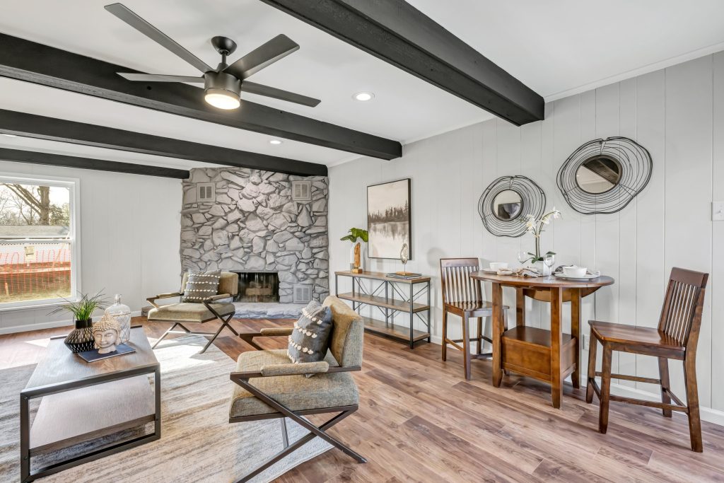 Living room with stone fireplace and exposed beams