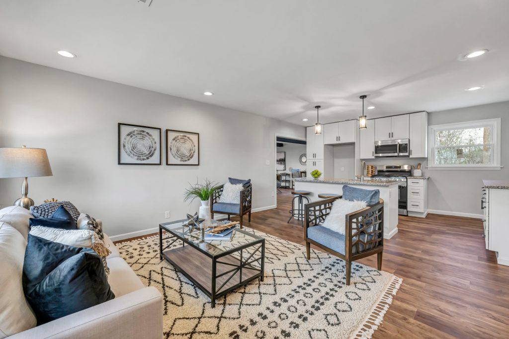 Living room with sofa and armchairs open to the kitchen