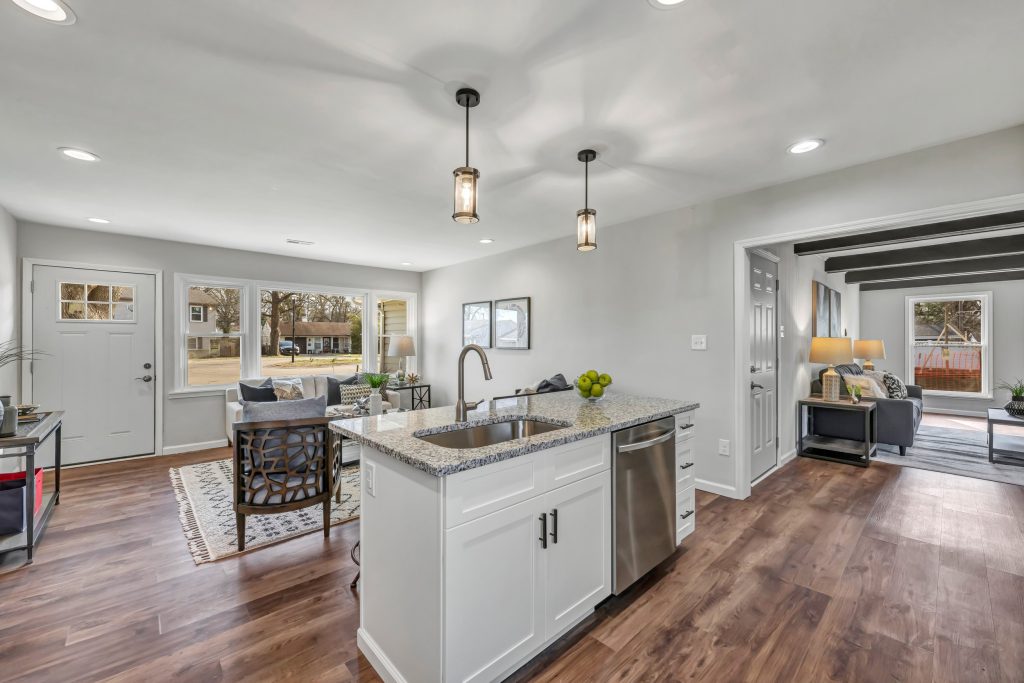 Kitchen island with pendant lights and living room beyond