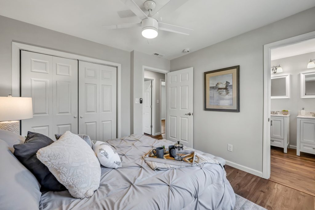 Bedroom with closet doors and en suite beyond