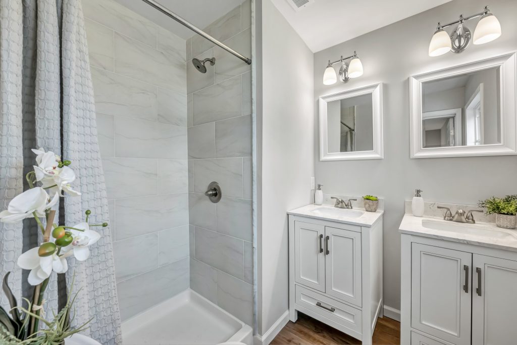 Bathroom with double vanity and glass shower