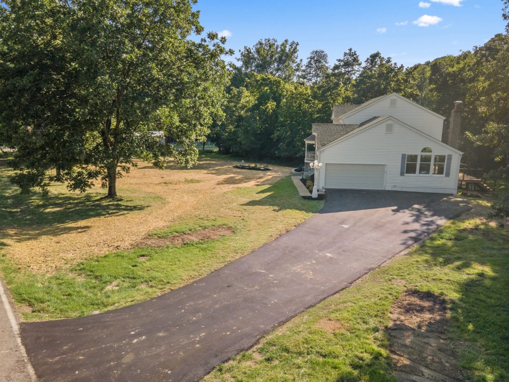 Aerial view of the house and long driveway