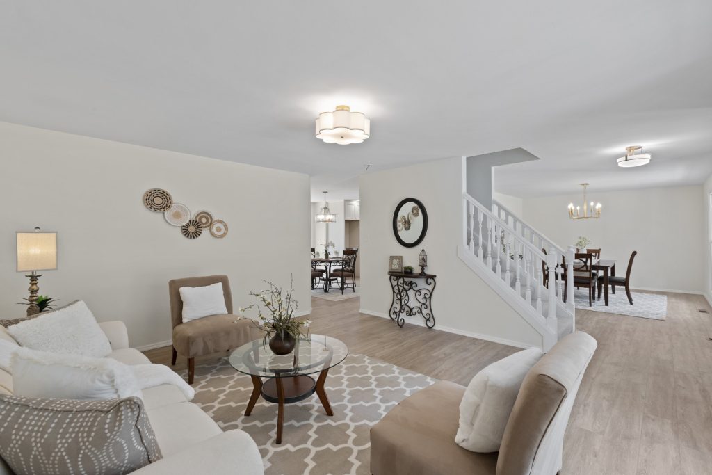 Living room with staircase and dining room beyond