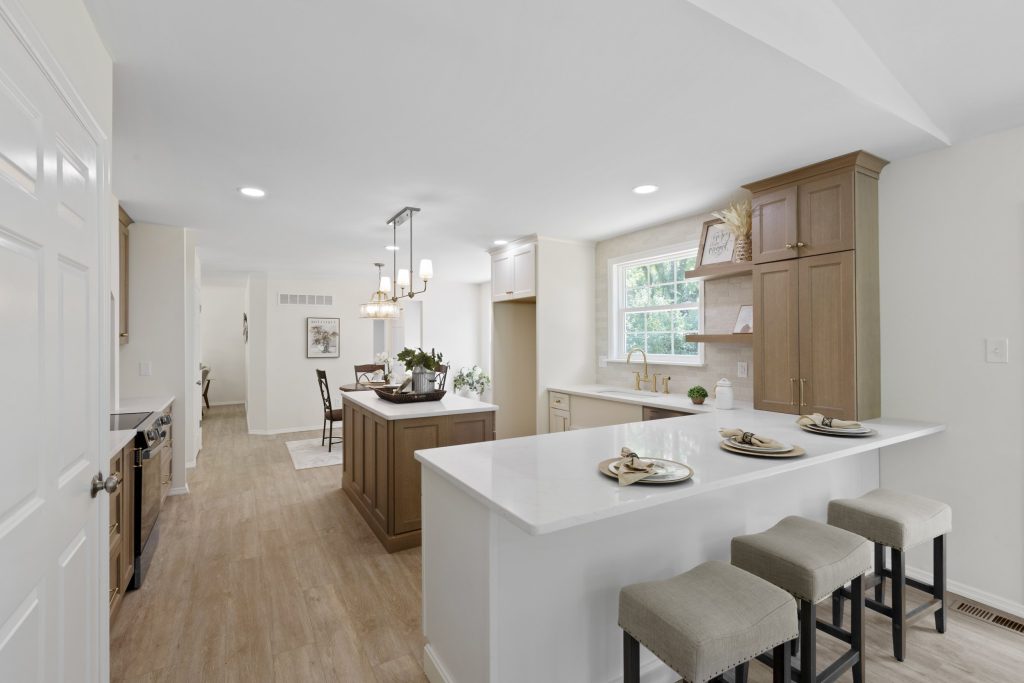 Kitchen with wood cabinetry and breakfast bar stools