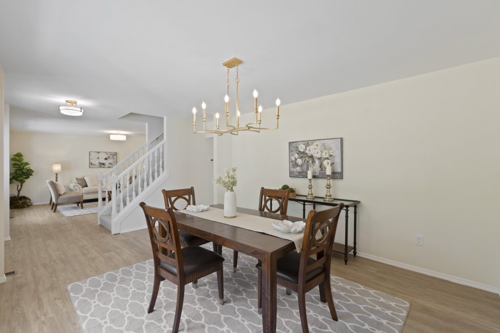 Dining room with wood table and staircase beyond