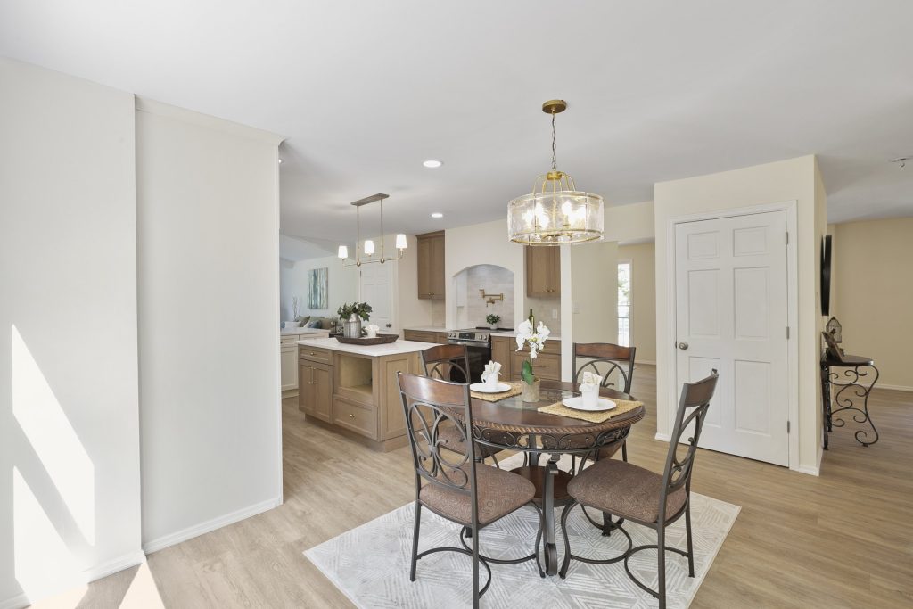Breakfast table with kitchen island beyond