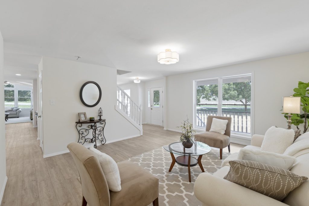 Entry hall with staircase, console table and round mirror