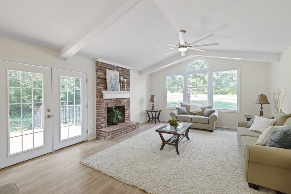 Family room with brick fireplace and French doors