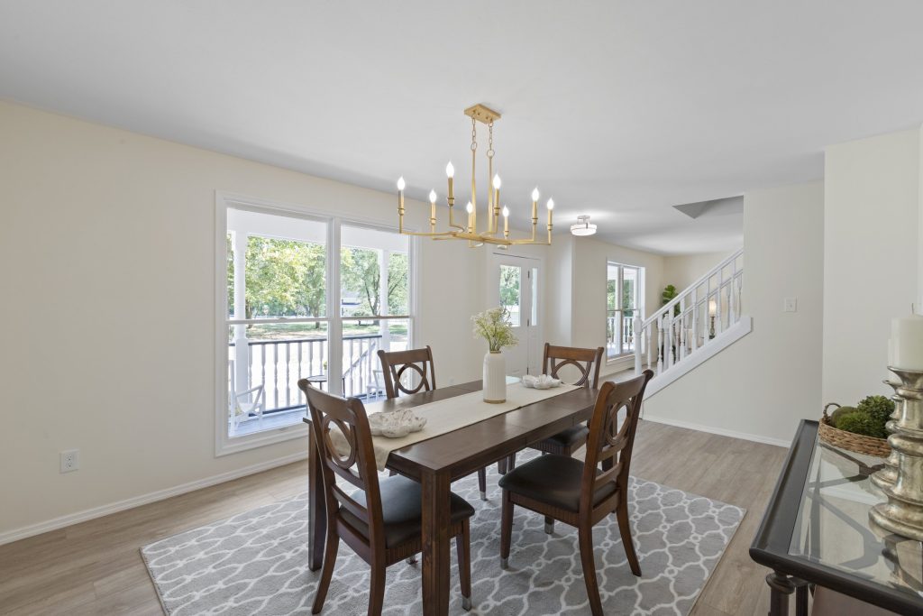 Dining room with chandelier and staircase beyond