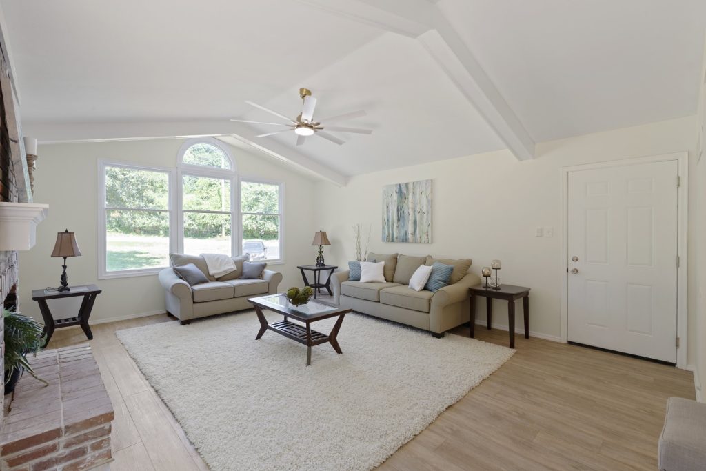 Sitting room with brick fireplace and vaulted ceiling