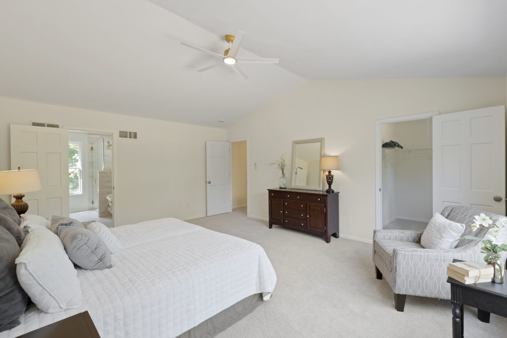 Primary bedroom with vaulted ceiling and en suite beyond