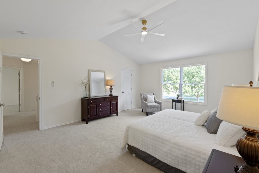 Bedroom with dresser, mirror and armchair