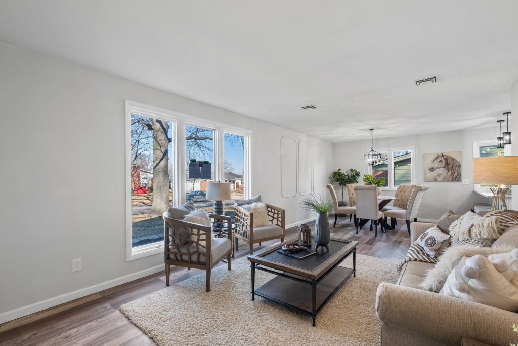 Living room with sofa, armchairs and dining area beyond