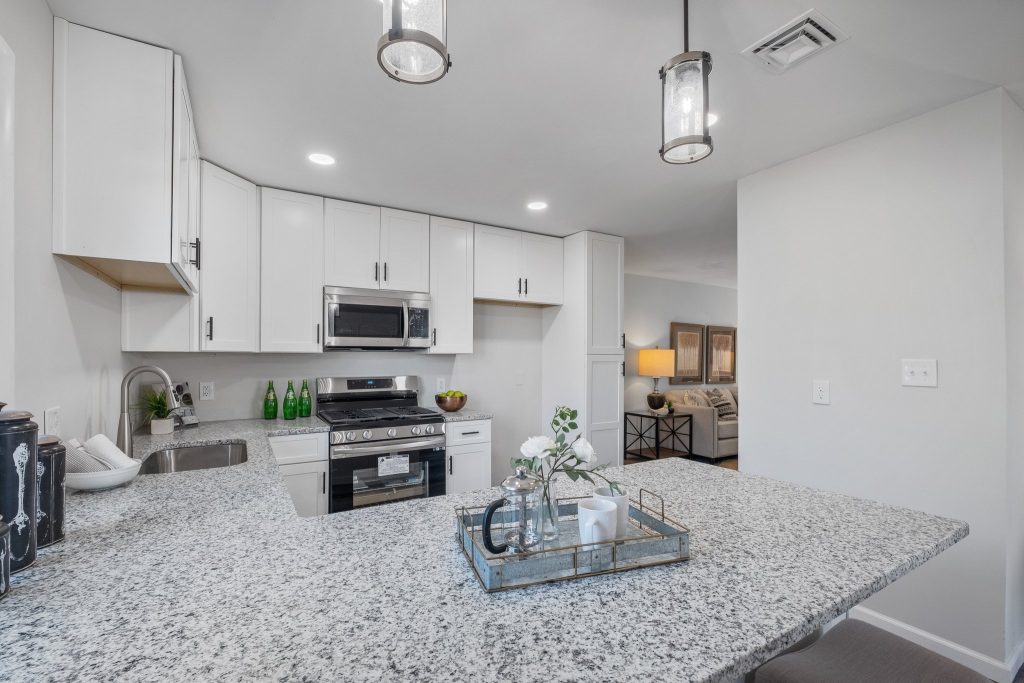Kitchen with granite island and stainless range