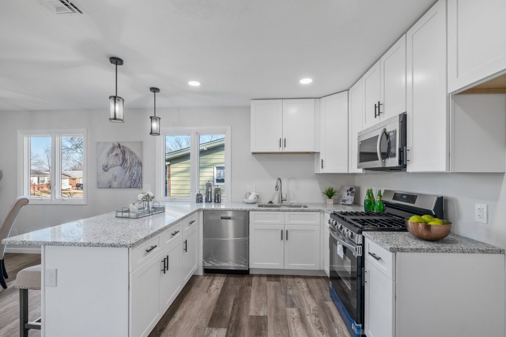 Kitchen with granite island, stainless range and dishwasher